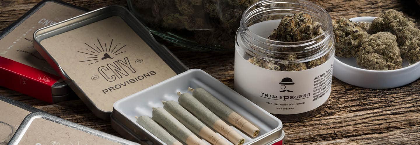 a package of pre-rolled joints and a container of cannabis buds