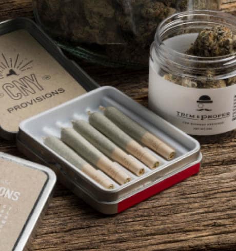 a package of pre-rolled joints and a container of cannabis buds