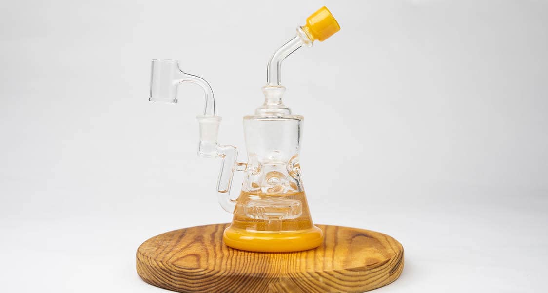a yellow dab rig on a clean backdrop
